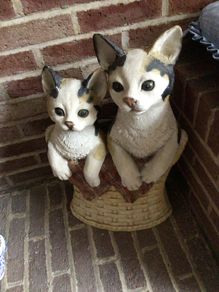 Tall vintage ceramic cats in basket with metal hooks