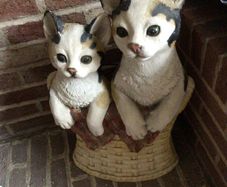 Tall vintage ceramic cats in basket with metal hooks