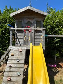 treehouse with swings slide climbing wall and gym bar