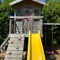 treehouse with swings slide climbing wall and gym bar