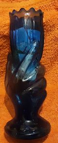 very unusual blue vase held in a hand