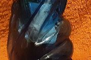 very unusual blue vase held in a hand