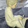 Porcelain Boy with Candle Nao by Lladro, depicting a seated child in a white nightshirt holding a small candle, postage available or collection Image 4