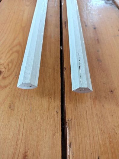 Two 2.4m lengths of white wooden moulding 10x10mm