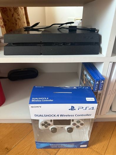 PS4 console with dual shock 4 controller and two COD games