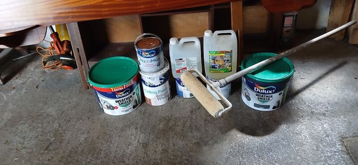 a selection of paint and a paint roller and some good paint brushes