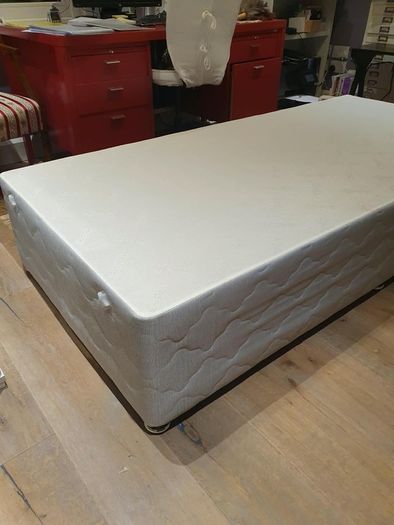 Single divan bed with pristine clean mattress and space for headboard