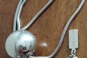 BEN DE LISI long necklace with a ball pendant.