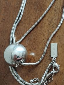 BEN DE LISI long necklace with a ball pendant.