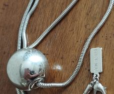 BEN DE LISI long necklace with a ball pendant.