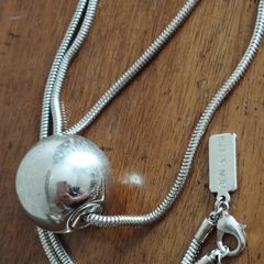 BEN DE LISI long necklace with a ball pendant.