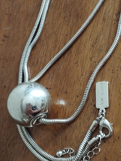 BEN DE LISI long necklace with a ball pendant.