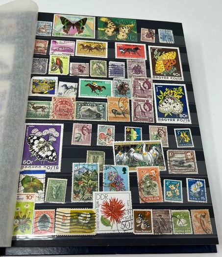 Ace Black 32 page/ 16 leaf Stamp Album with over 900 stamps. Thematic of Animals, Plants, Classic Cars, Space, Trains, Sport & Disney noted.