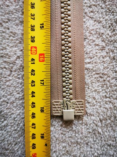 Zip, beige, separates /splits to be sewn into the jacket