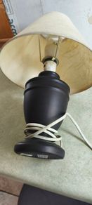 Small black carmic table lamp and shade in working order.38 cm, tall all togther.