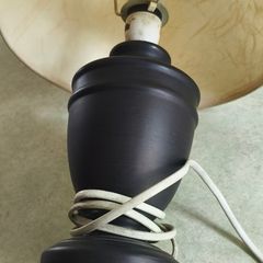 Small black carmic table lamp and shade in working order.38 cm, tall all togther.