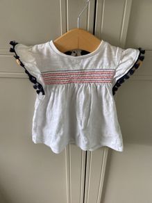 2 piece baby outfit navy leggings white top with neon orange thread detail & navy fringing on capped sleeves