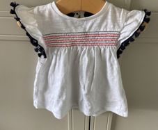2 piece baby outfit navy leggings white top with neon orange thread detail & navy fringing on capped sleeves