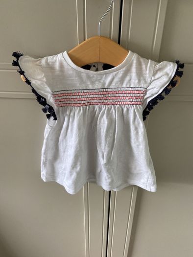 2 piece baby outfit navy leggings white top with neon orange thread detail & navy fringing on capped sleeves