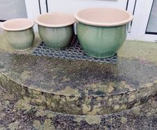 Matching sets of green glazed clay pots