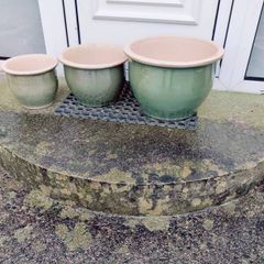 Matching sets of green glazed clay pots