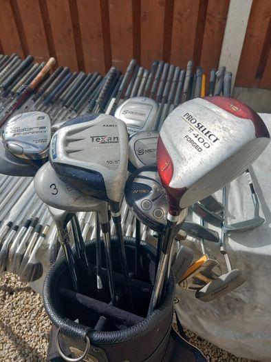 A selection of Golf clubs. Bags and golf balls.