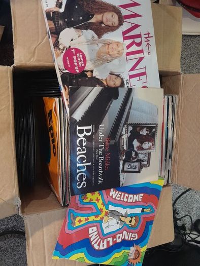 a box of 7" singles. 45 rpm vinyl records.