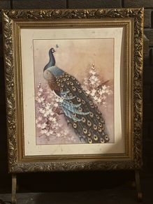 vintage-style peacock artwork in an ornate gold-coloured frame
