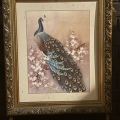 vintage-style peacock artwork in an ornate gold-coloured frame