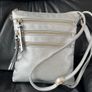 Silver crossbody handbag with contrasting gold zips & hardware  In excellent condition. Purchased in Toulouse Image 5