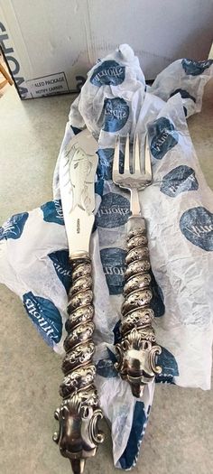 Silver-plated utensil fish carving set or serving set, noted by the specific shape of the knife blade.