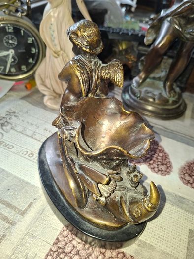 Antique French 19th century Bronze Sculpture Auguste Moreau featuring a Winged Putto Cherub Cupid carrying a shell or cornucopia like vessel, mounted on a marble base