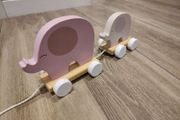 Baby pulling elephant train
