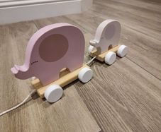 Baby pulling elephant train
