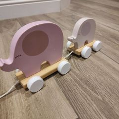 Baby pulling elephant train
