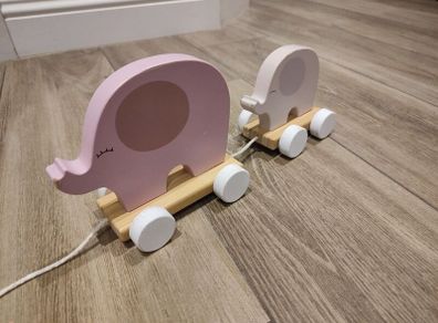 Baby pulling elephant train