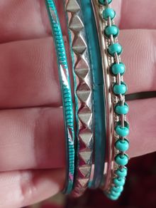 Charming bracelets in silver and blue tones.