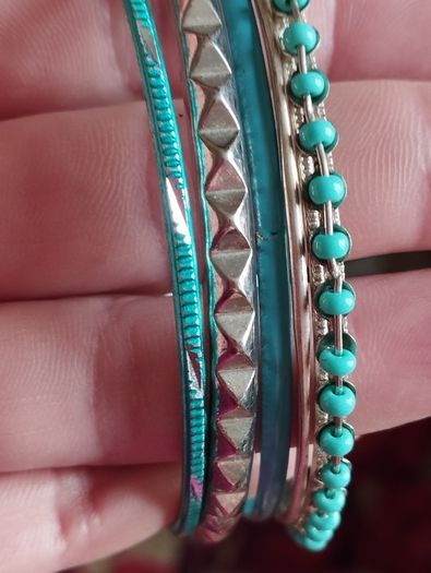 Charming bracelets in silver and blue tones.