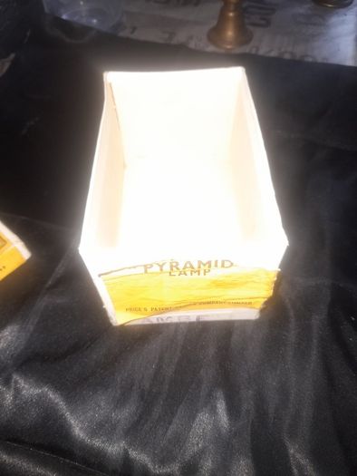 Clarkes Pyramid lamp night light and an Advertisment Box, comprising a white glazed ceramic reservoir marked Prices Patent Candle Company Limited, London