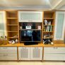 large wooden entertainment center or wall unit featuring a mix of open shelving, glass fronted cabinets, and lower drawers Image 2