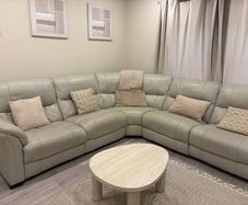 Cream leather reclining sofa with charging ports