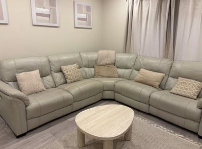 Cream leather reclining sofa with charging ports