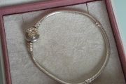 Pandora two-tone signature braceletsterling silver snake chain and a 14K gold logo clasp, size 18cm