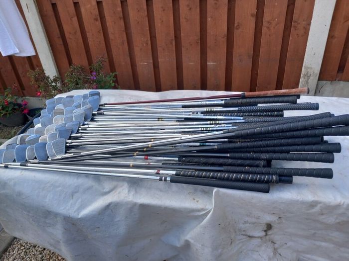 A selection of Golf clubs. Bags and golf balls.