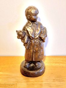 Boy Statue in a Home Dress with Bear Toy & Books.
