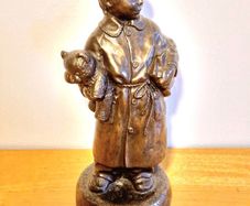 Boy Statue in a Home Dress with Bear Toy & Books.