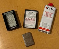 Original Zippo Petrol Lighter Quit smoking. Included: - Zippo lighter like new in its box - Fuel canister about 90% full - Bic lighter