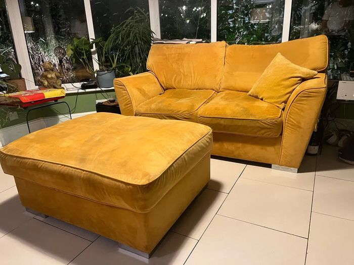 Mustard yellow velvet sofa with matching footstool