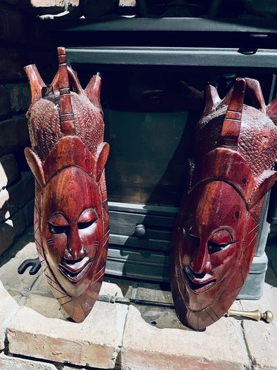Two carved tribal masks