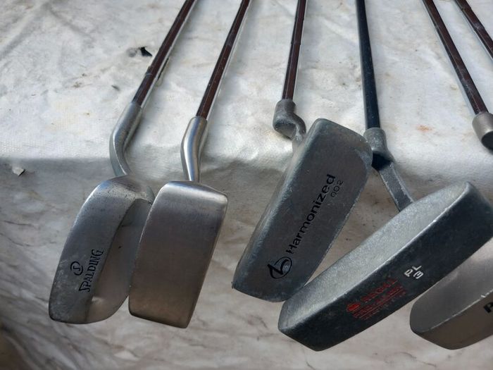 A selection of Golf clubs. Bags and golf balls.
